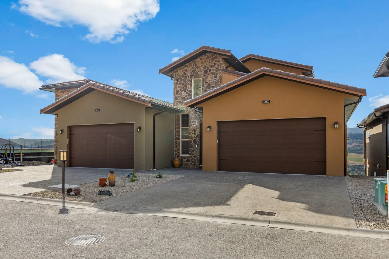 The garages and stone entry of a Vineyard Way duplex