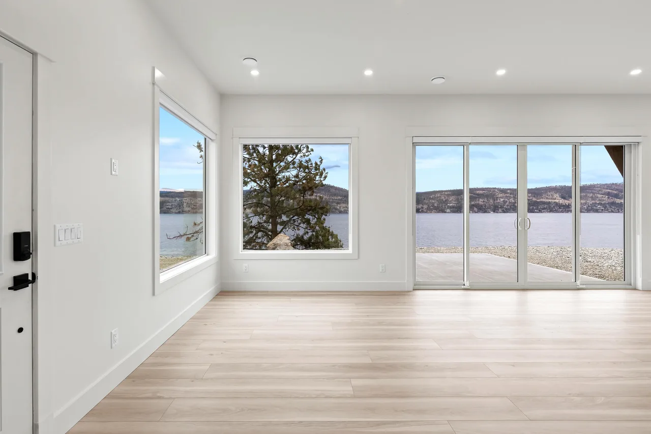 The open living area, with windows and sliding doors onto the lake